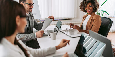 Three business people working in the office and on computers